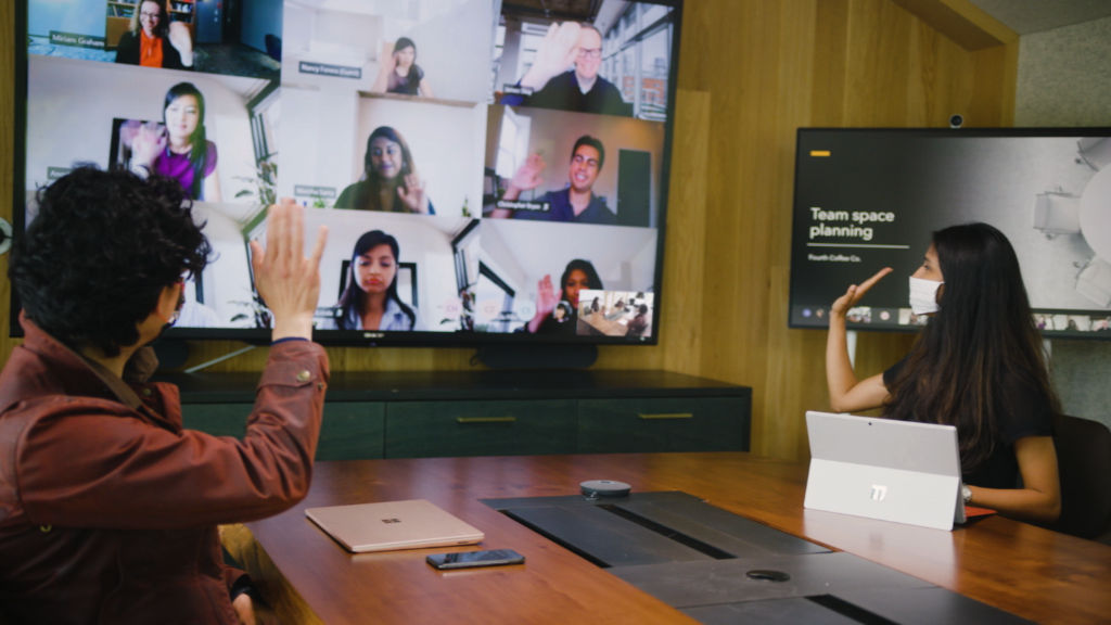 Image showing people collaborating digitally and in-person with Breakout rooms from Microsoft Teams