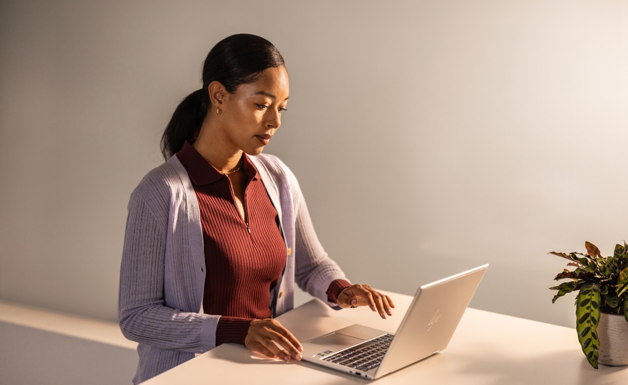 A woman sitting at a desk using a laptop
