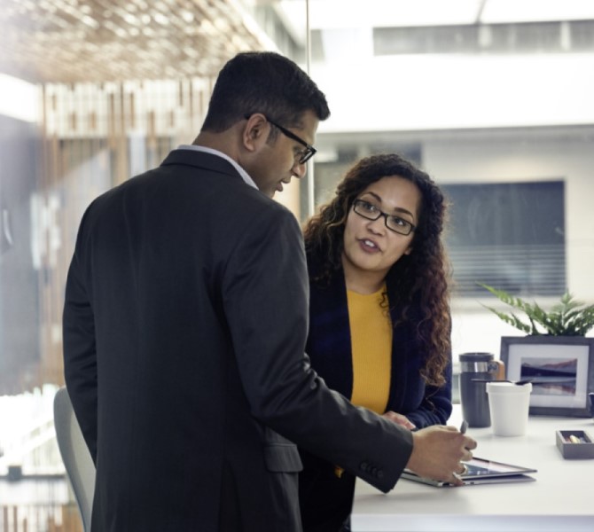 a man and a woman standing in front of a window