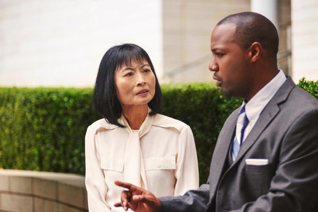 Two government employees sitting outside talking