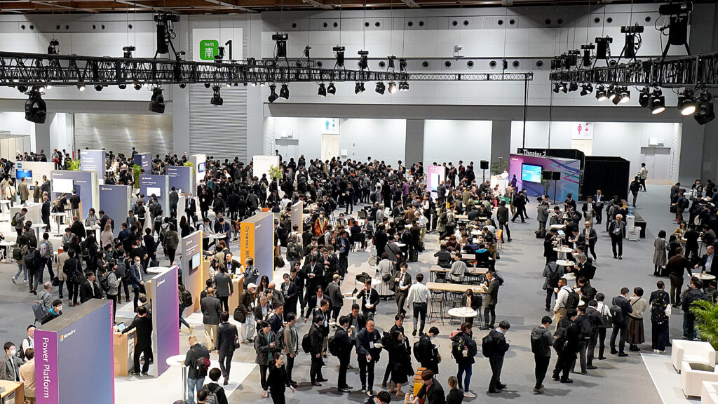 A conference room of business decision makers exploring Microsoft exhibits at the Microsoft AI Tour stop in Japan