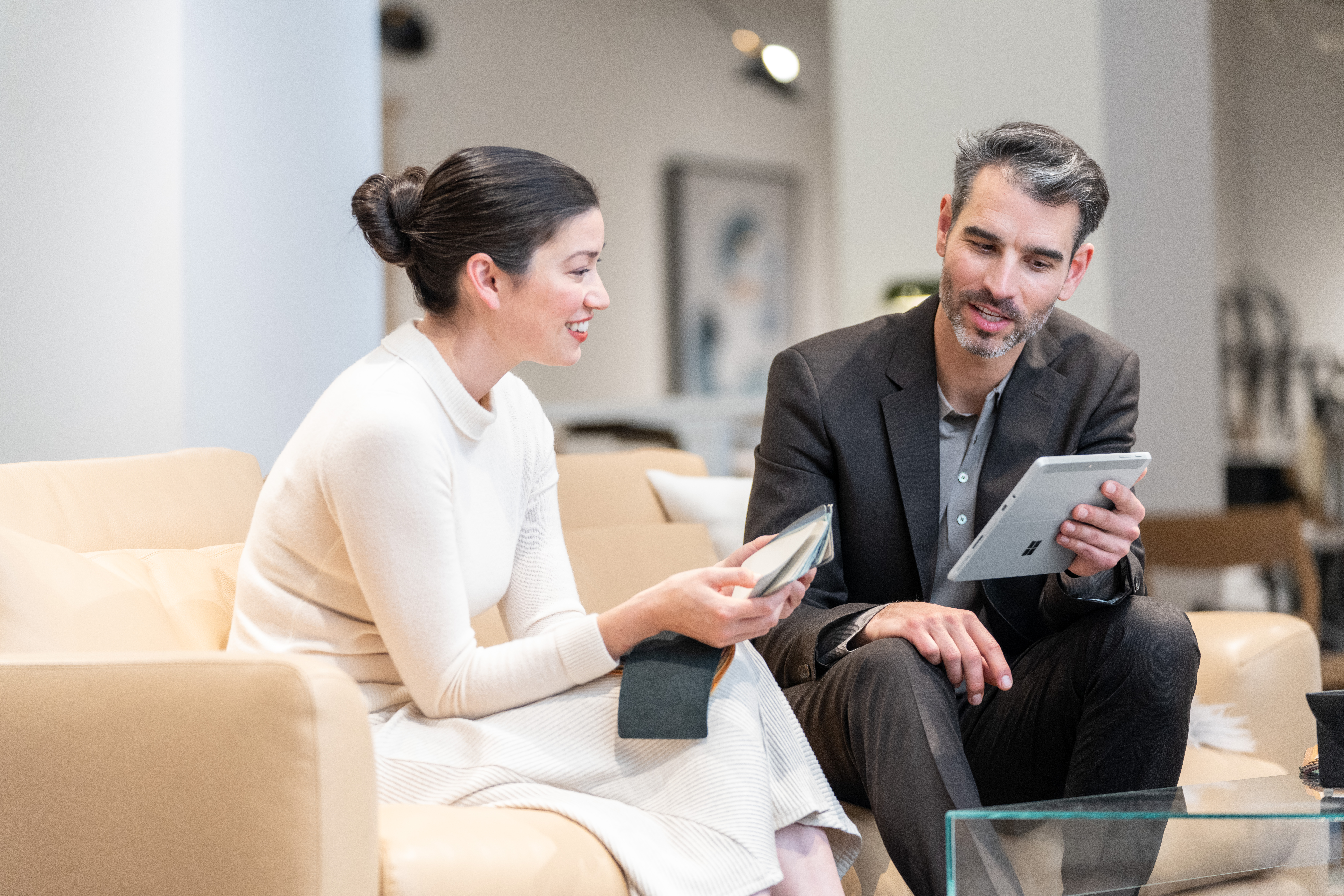A store Associate shows a customer product offerings using a Surface Pro and D365 Supply Chain Management