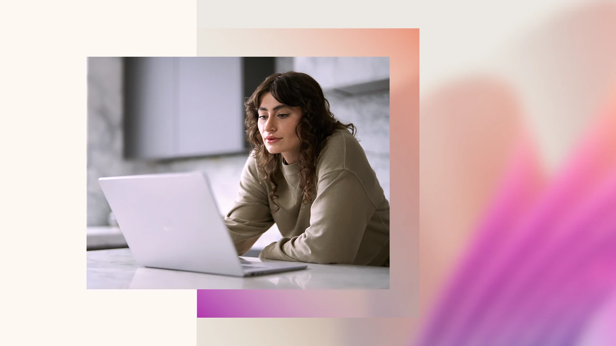 A woman looking at a laptop