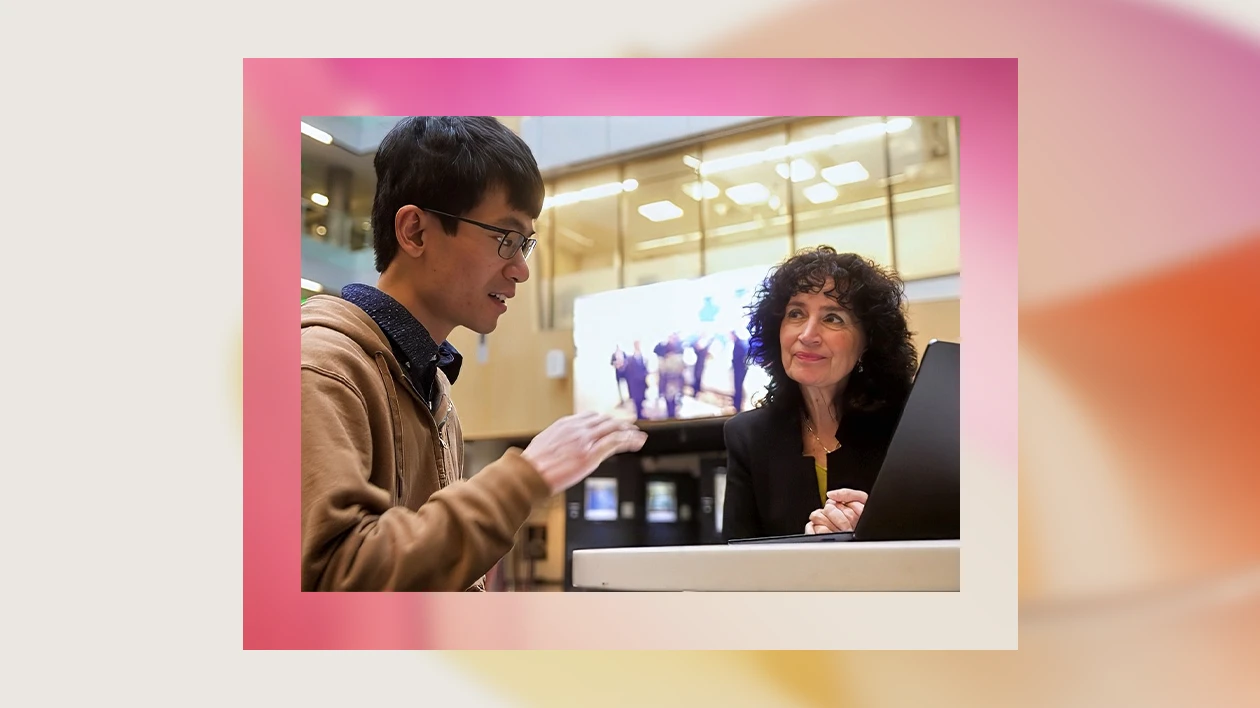 A man and woman looking at a laptop