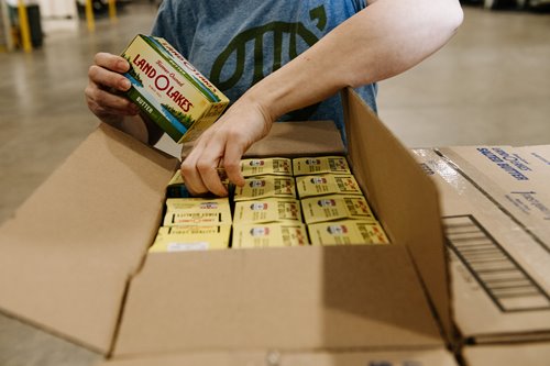 A warehouse worker packing Land O'Lakes butter to ship.