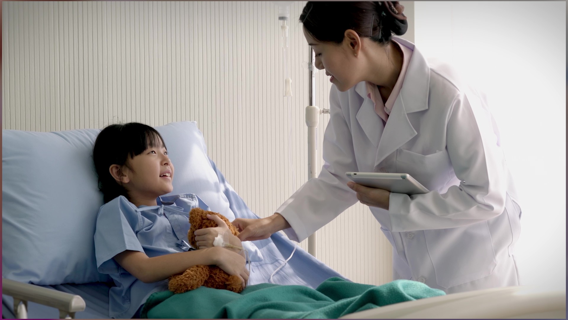A young patient smiles at her doctor.