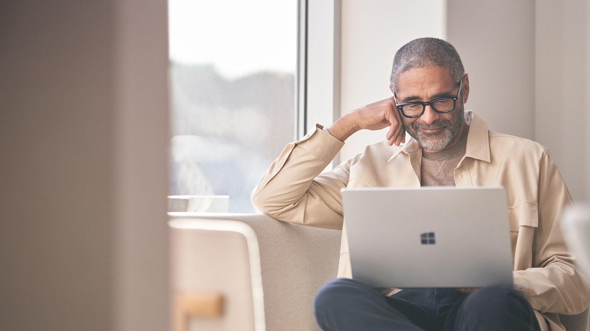 A person working on a laptop in an office