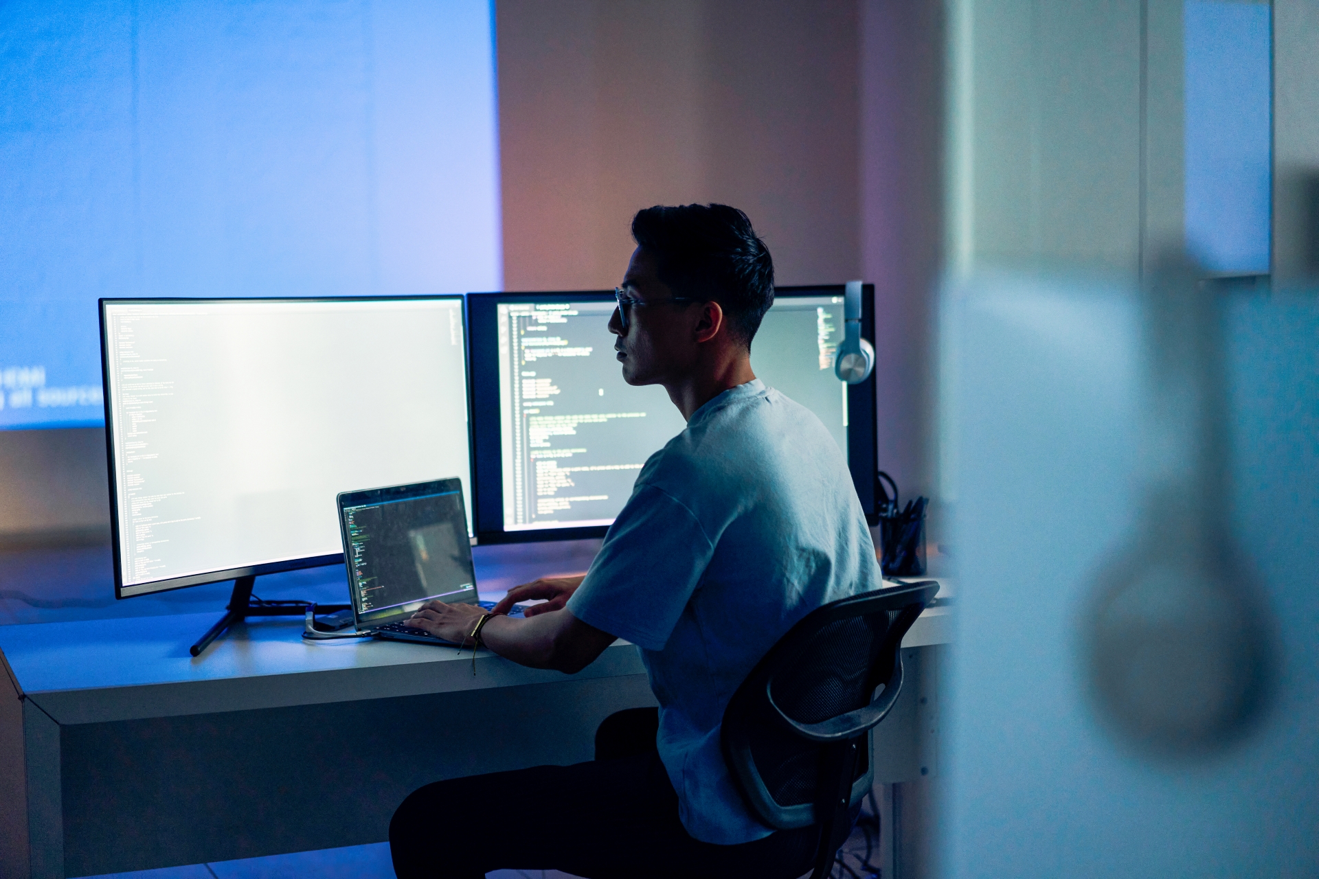 A man sitting at a desk with a laptop