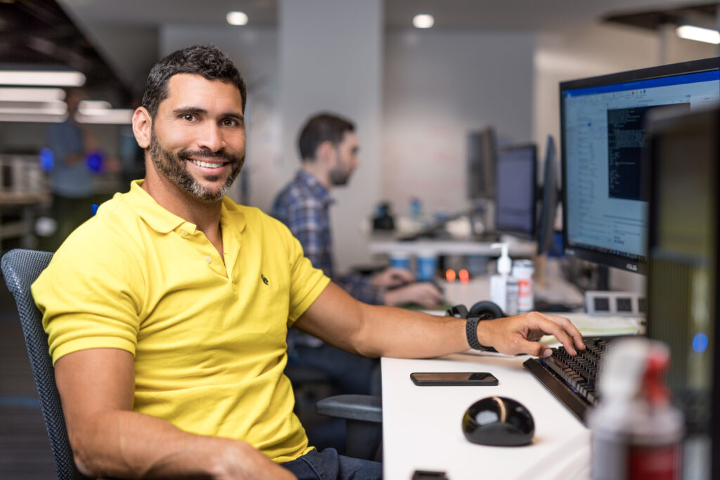 A man sitting at a desk with a computer
