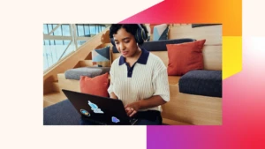 A woman wearing headphones and using a laptop