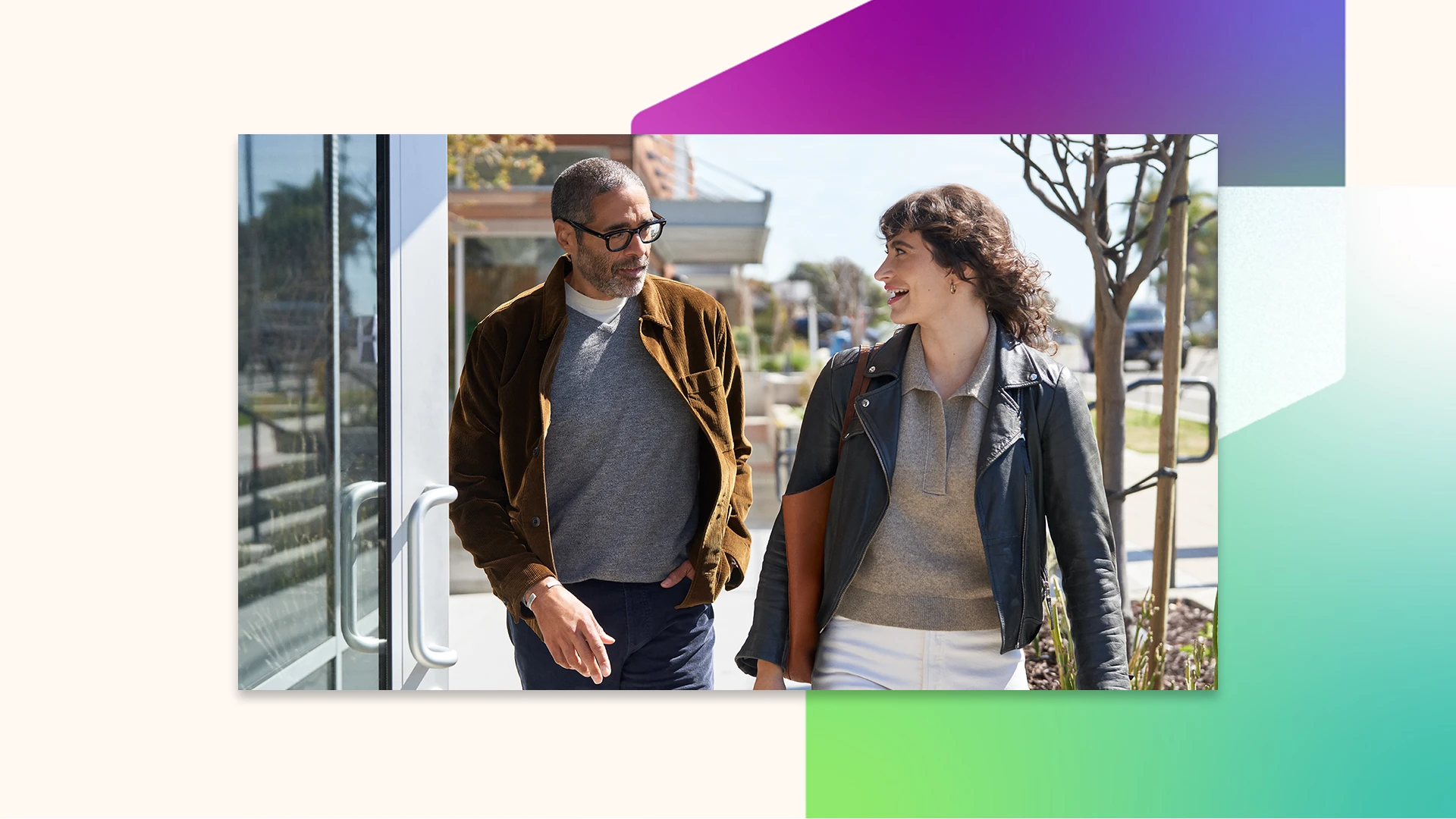 Two people walking and talking outside