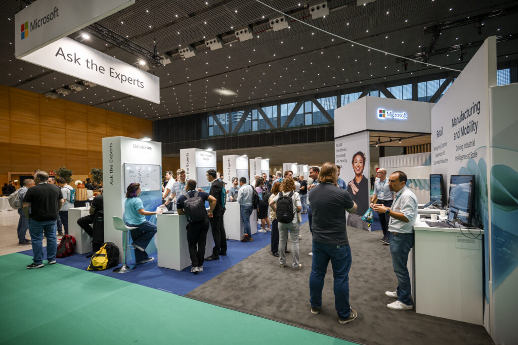 FabCon and SQLCon attendees converse at Microsoft booths.