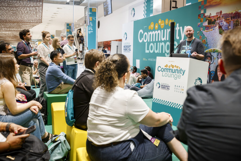 Attendees listen to a speaker at the Community Lounge at FabCon and SQLCon Barcelona.
