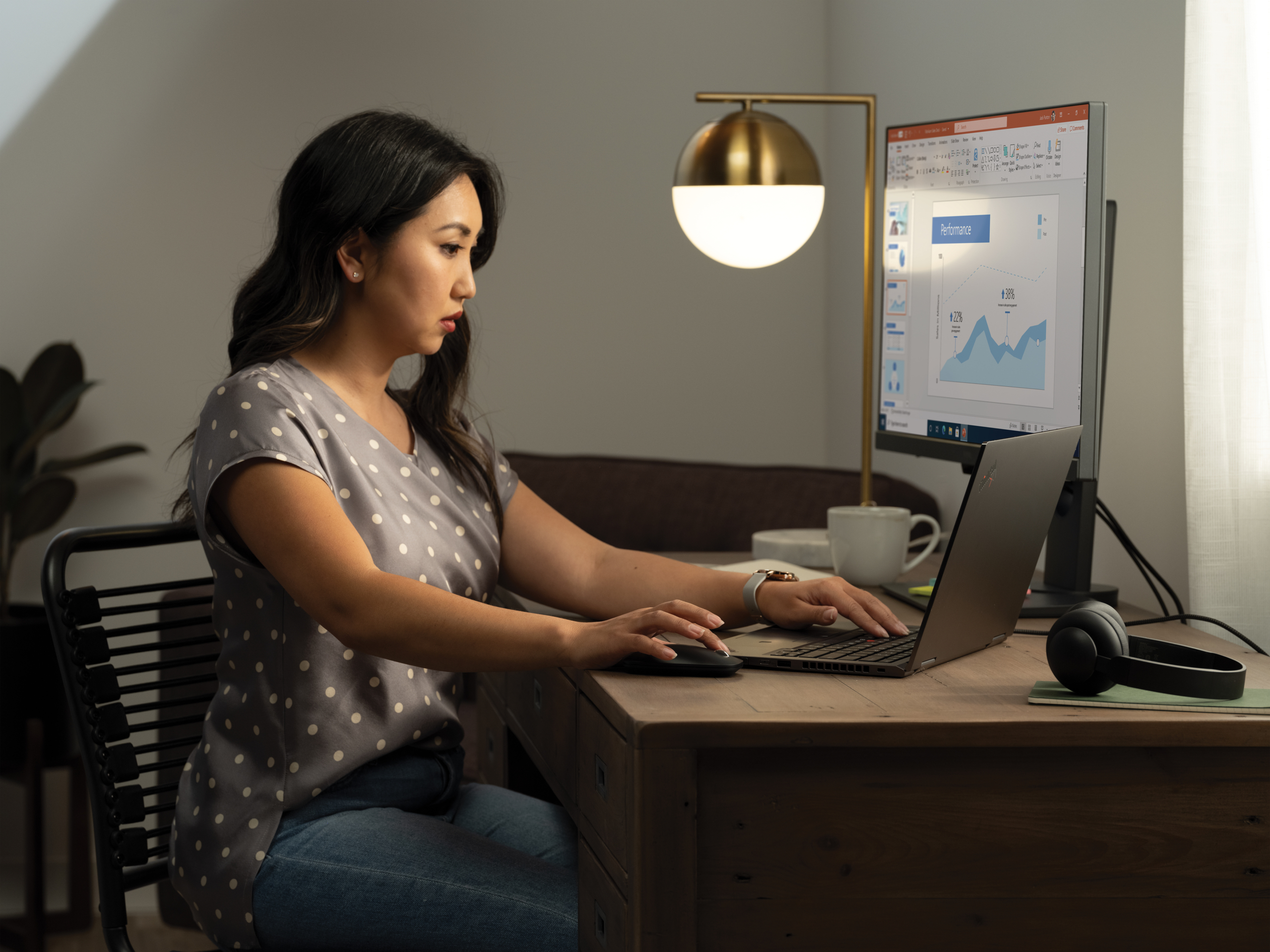 a woman sitting at a desk in front of a computer