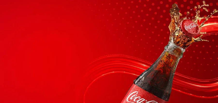 Opened Coca-Cola bottle with soda spilling out the top