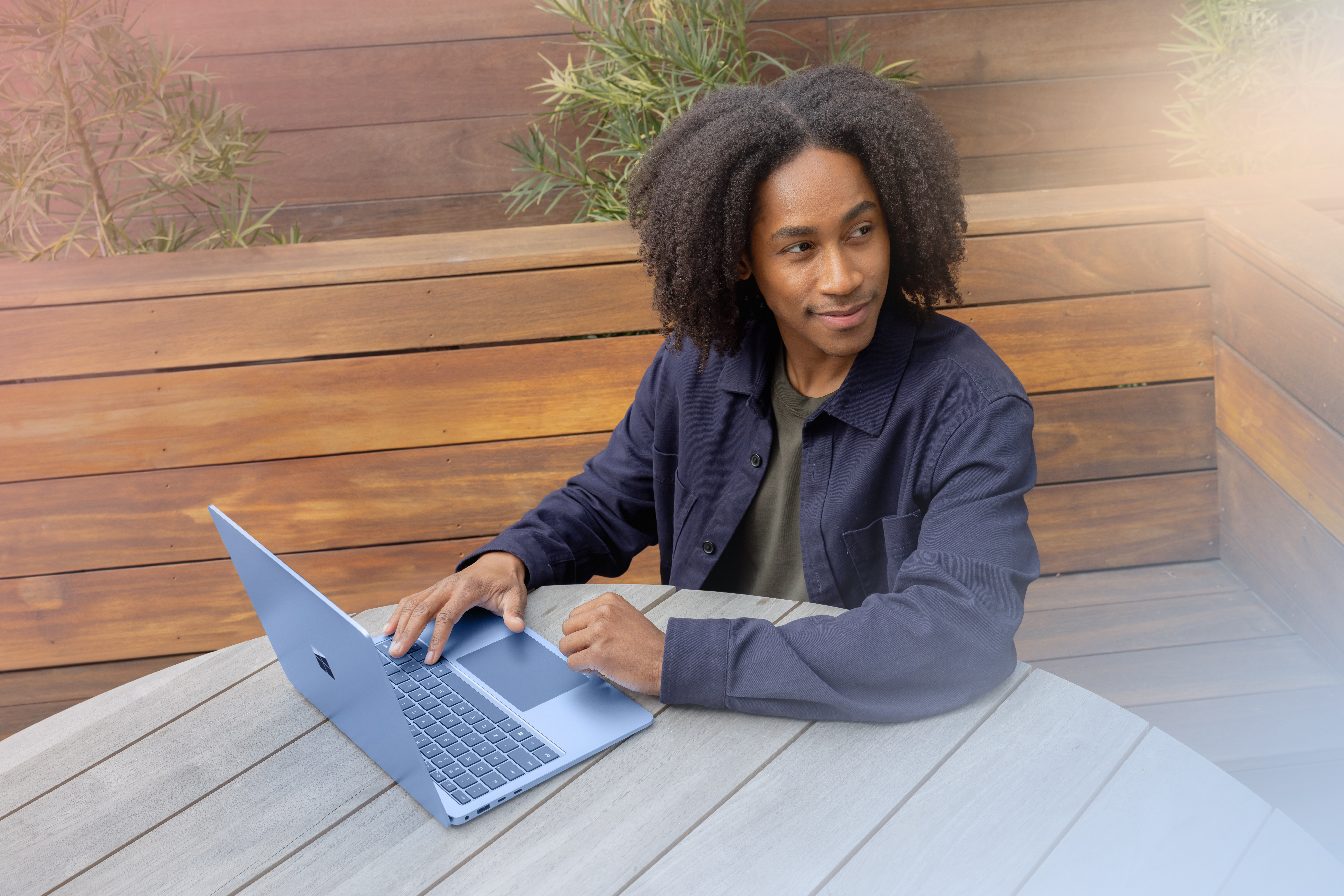 A man sitting at a table with a laptop