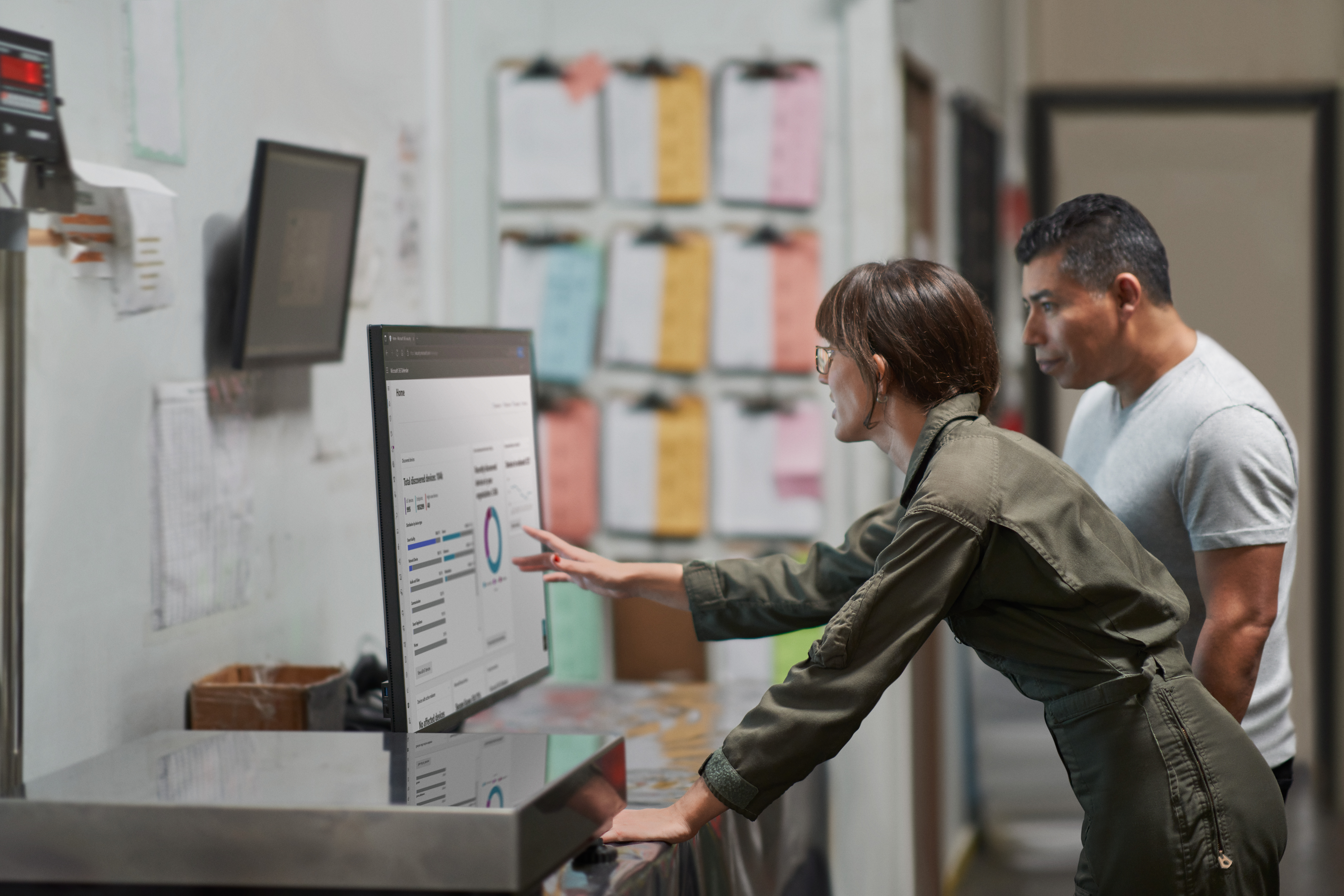 A man and woman looking at a computer screen