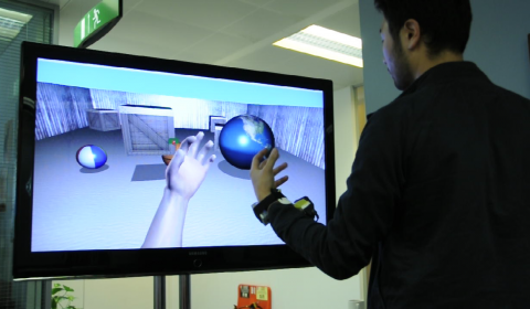 a man standing in front of a computer screen