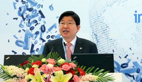 a person standing in front of a flower