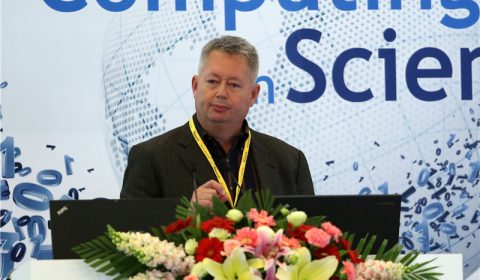 a person standing in front of a flower