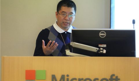 a screen shot of a man in a suit and tie