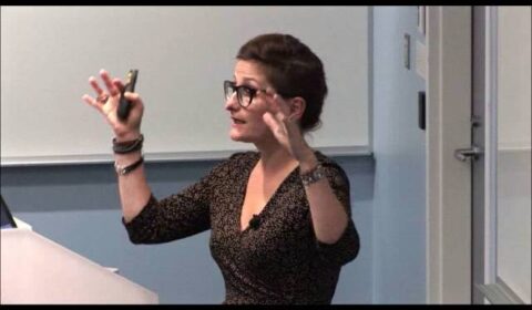 a woman standing in front of a mirror posing for the camera