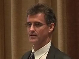 Antony John Williams wearing a suit and tie