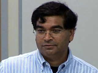 Joy Laskar wearing a blue shirt