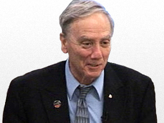 Mario Livio wearing a suit and tie