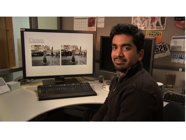 a man standing in front of a computer
