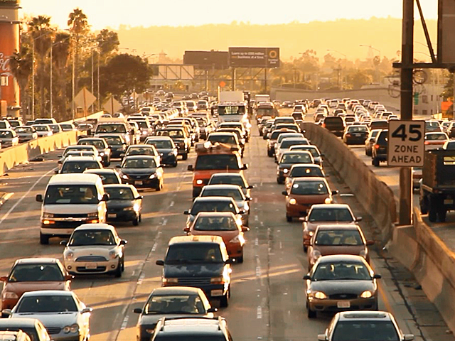 a view of a city street filled with lots of traffic
