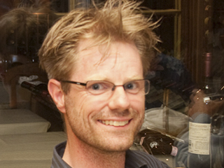 K. Rustan M. Leino wearing glasses and smiling at the camera