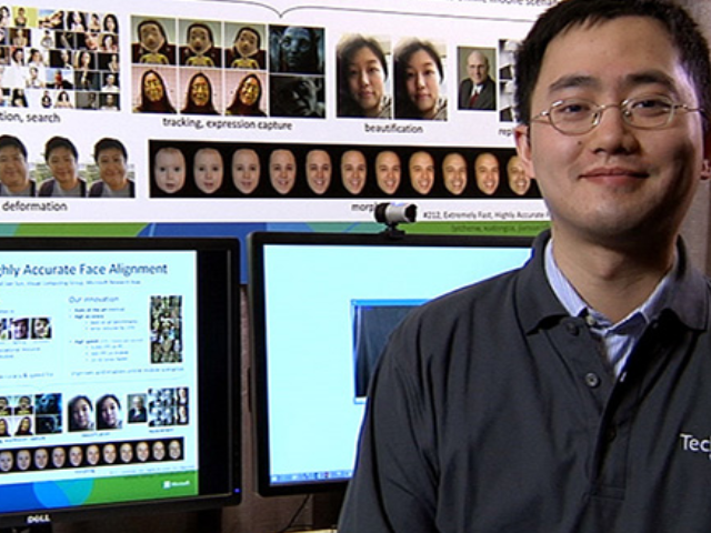 a man standing in front of a computer