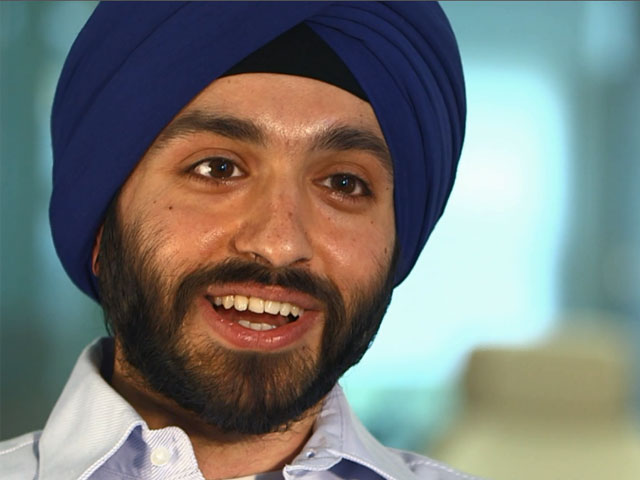 a man wearing a hat and smiling at the camera