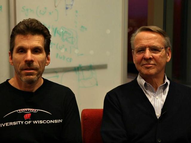 a man standing in front of a group of people posing for the camera