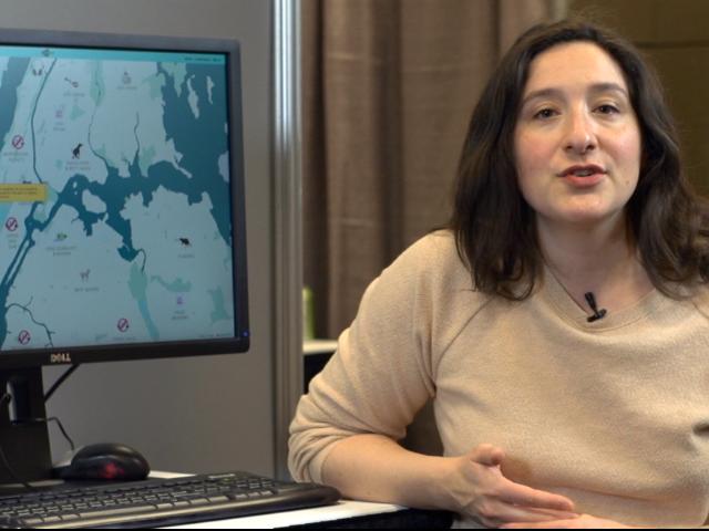 a woman standing in front of a computer