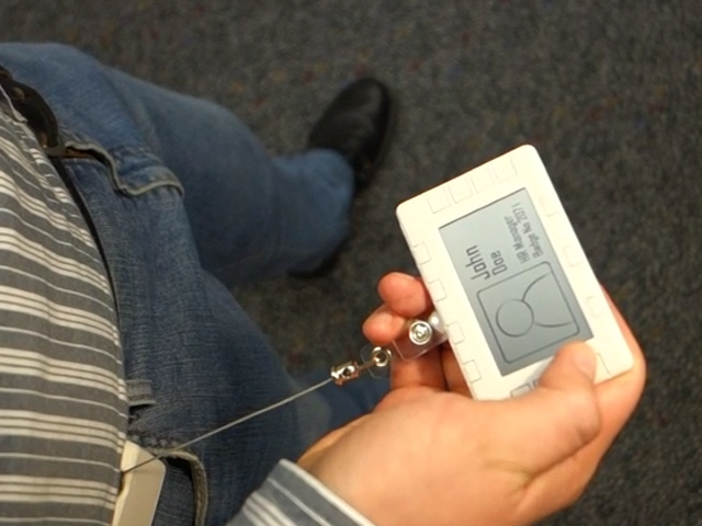 a hand holding a remote control