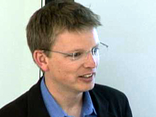 Nathan Eagle wearing a suit and tie