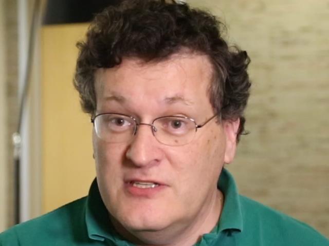 John Platt wearing glasses and smiling at the camera