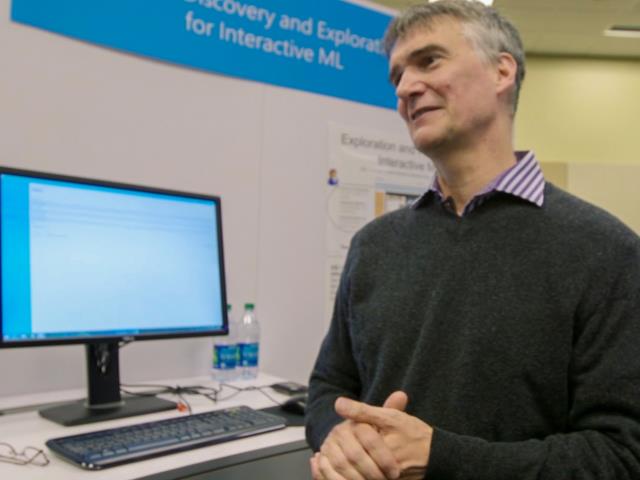 a man standing in front of a computer