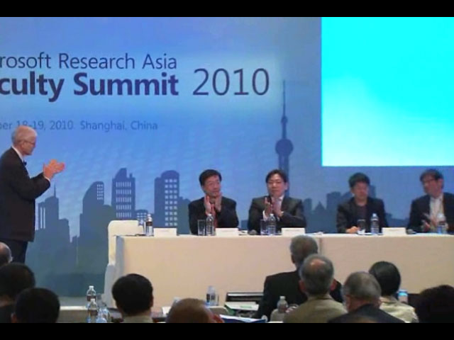 a group of people in front of a screen