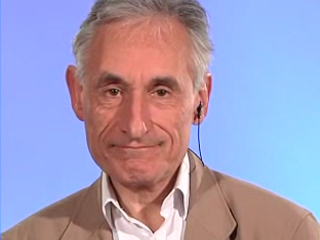 Andrew Blake wearing glasses and smiling at the camera