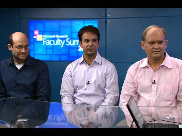 David Pennock, Robin Hanson standing in front of a screen