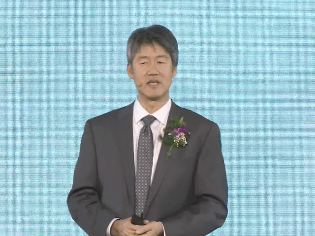 Peter Lee wearing a suit and tie