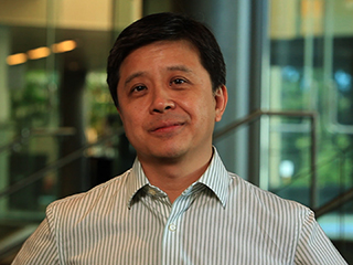 Hsiao-Wuen Hon wearing a striped shirt