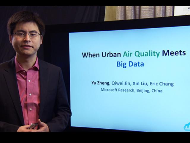a screen shot of a smiling man wearing a suit and tie