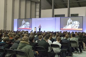 a group of people sitting in front of a crowd