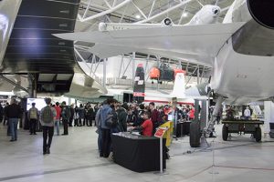 a group of people standing around a plane