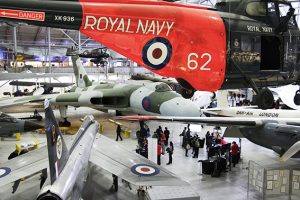 a group of people standing around a plane