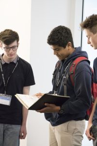 a group of people looking at a laptop